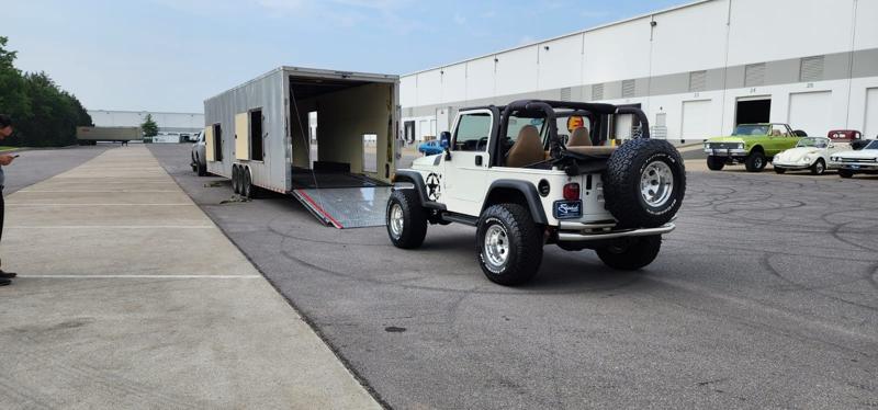 Jeep loading into enclosed transport trailer