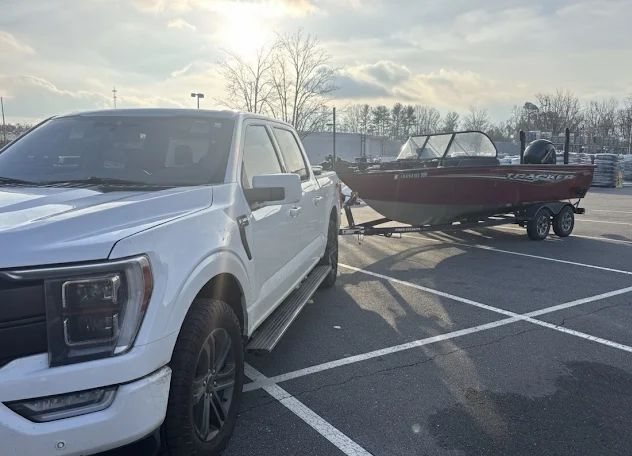 Fishing boat on its trailer behind a pickup