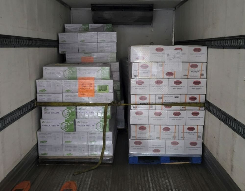 Frozen seafood pallets strapped in a reefer trailer