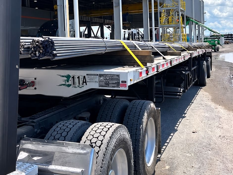 Steel bar bundles on a flatbed at a mill